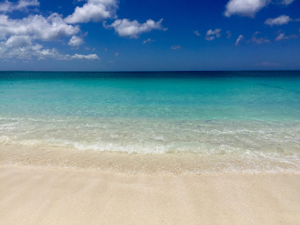 The perfectly colored beach, tan sand, clear water and blue sky's—The Turks and Caicos Islands. Travel Planning Guide