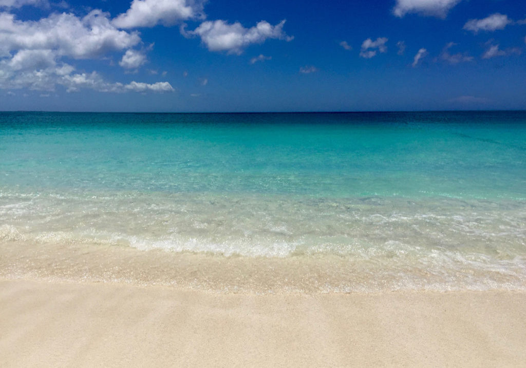 The perfectly colored beach, tan sand, clear water and blue sky's—The Turks and Caicos Islands. Travel Planning Guide