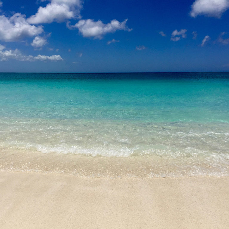 The perfectly colored beach, tan sand, clear water and blue sky's—The Turks and Caicos Islands. Travel Planning Guide